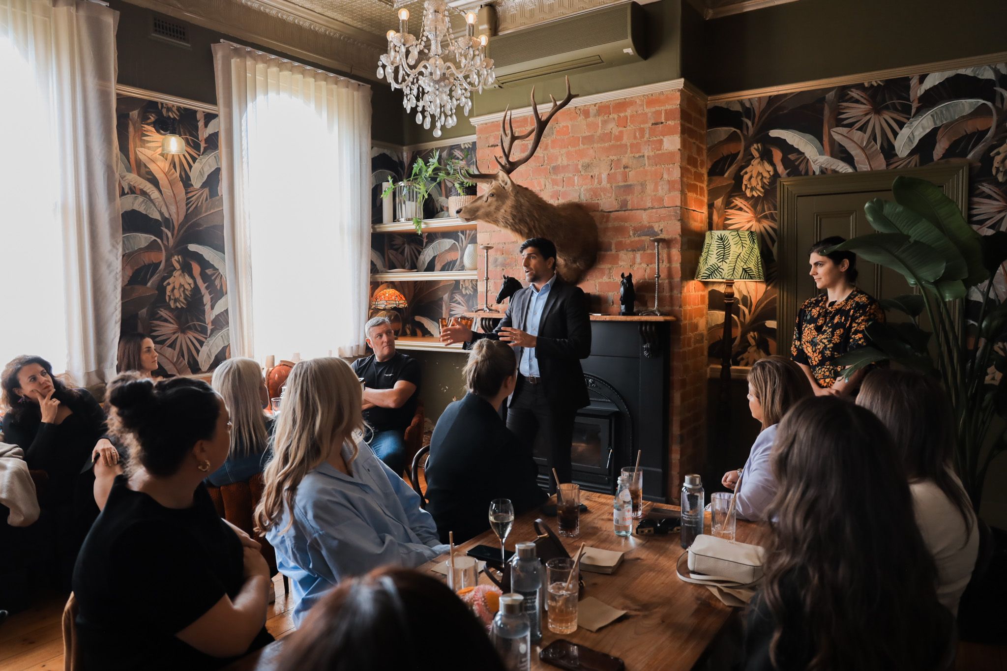 A speaker and guests in conversation.