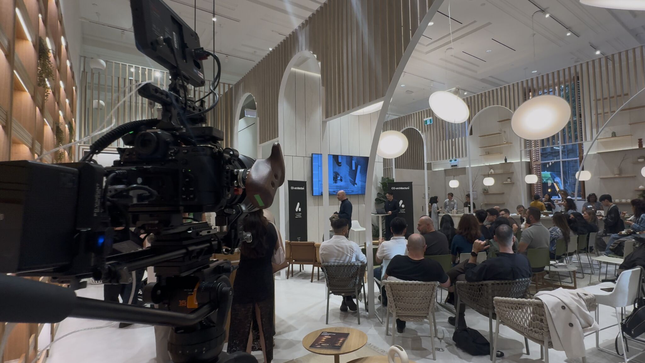 A camera follows the action on set.