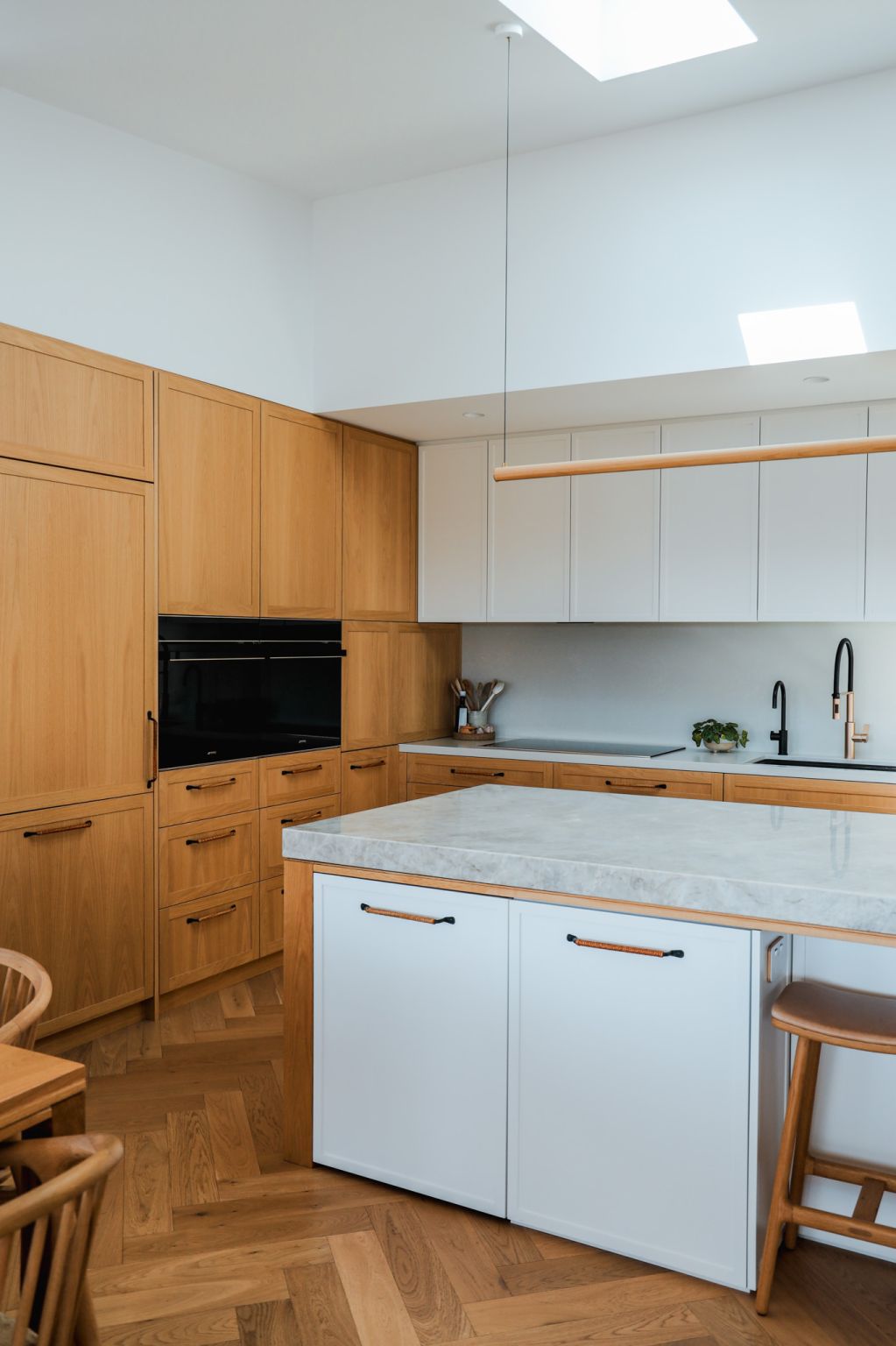 A calm kitchen in oak and stone.